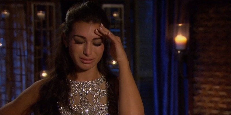 A woman cries and holds her forehead in 'The Bachelor'. A woman cries and holds her forehead in 'The Bachelor'.