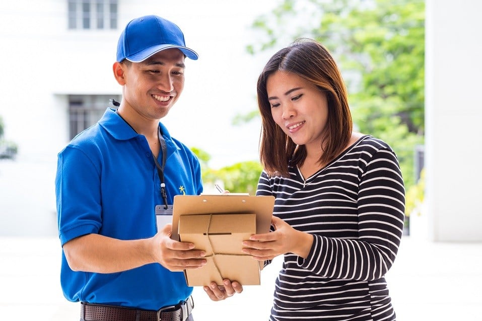 woman signing receipt of delivered package