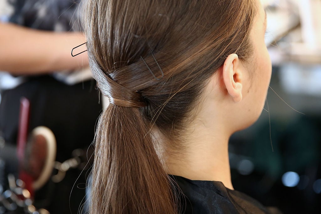 A model, hair detail, prepares backstage at the Fashion Palette Australian Womenswear fashion show