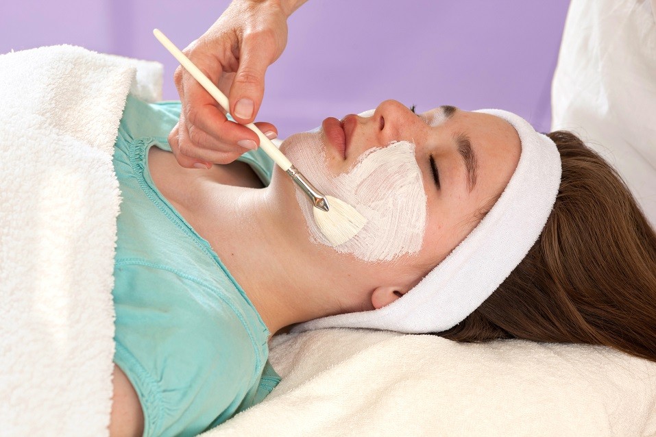 Alternative practitioner performing a chemical face peel