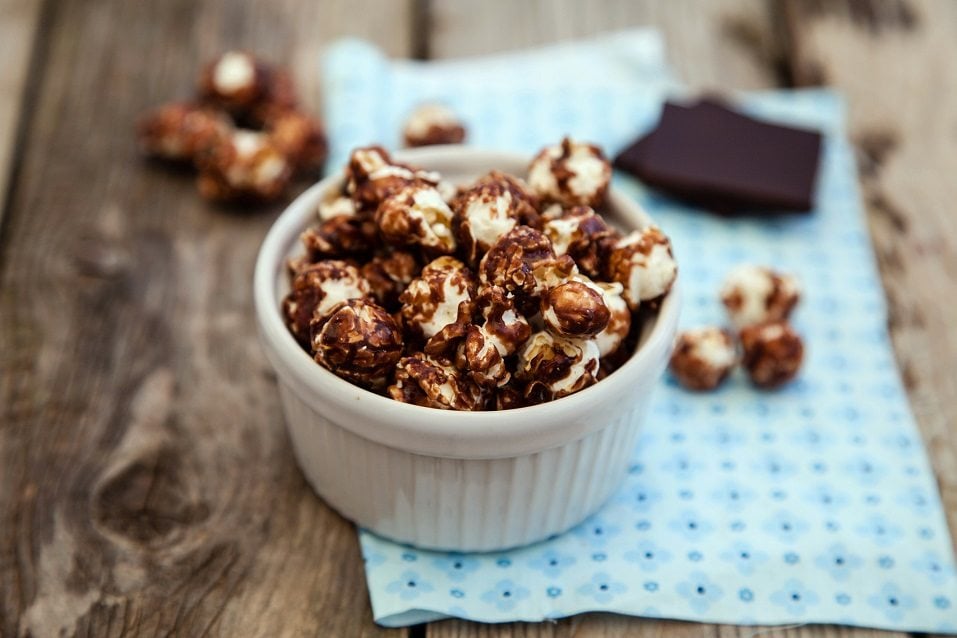 Chocolate covered popcorn in a white bowl