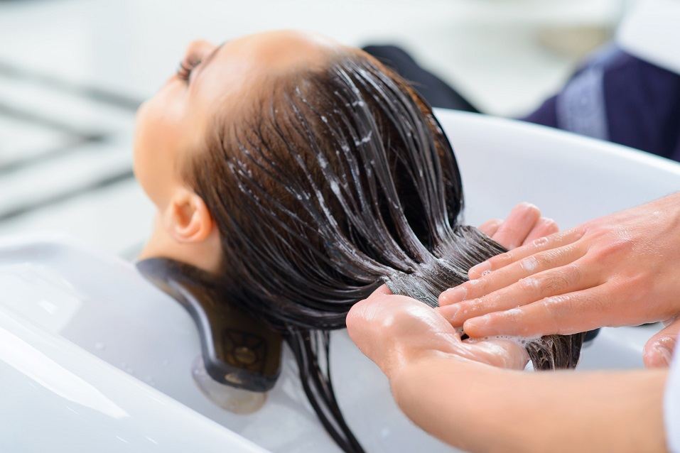 Client is resting while her hair is being taken professional care