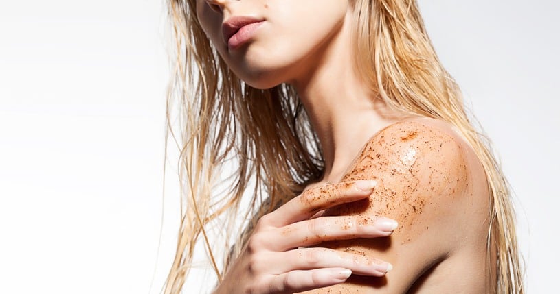 woman's shoulder with scrub of coffee