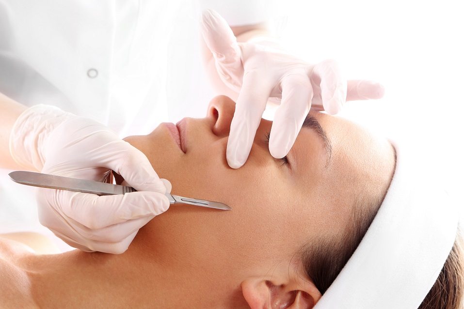 woman during surgery using a scalpel