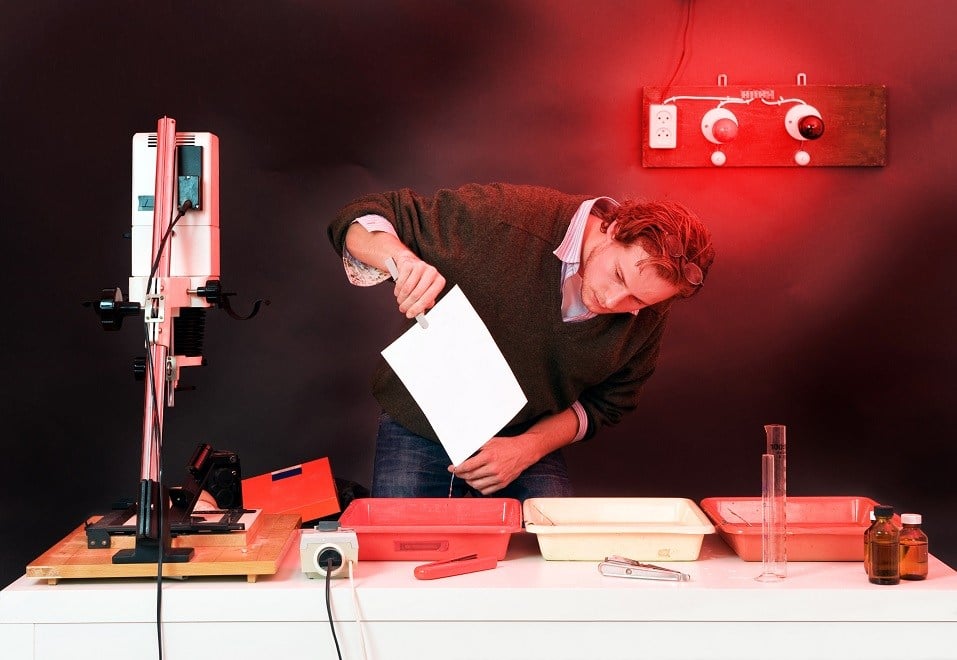 Photographer at work in a darkroom