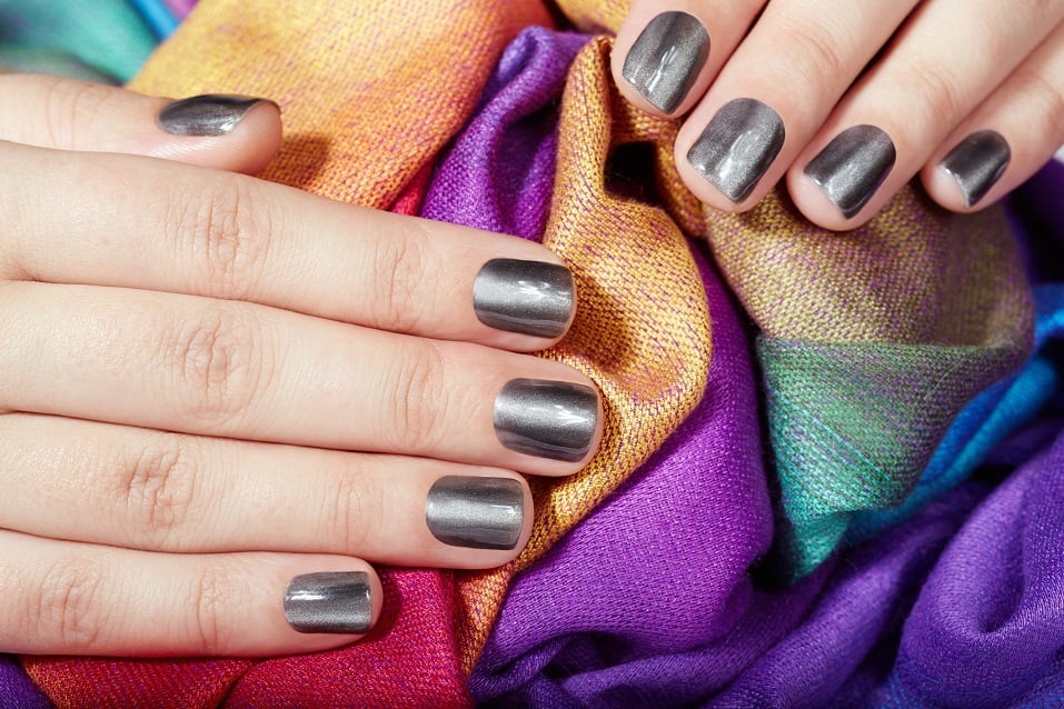Hands with gray metallic manicured nails