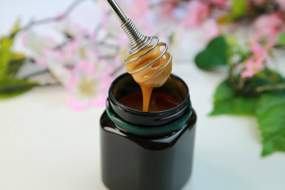 honey in a black jar