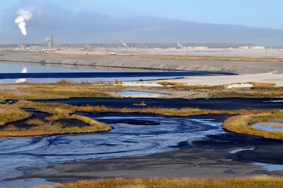 Oil mixes with water and land