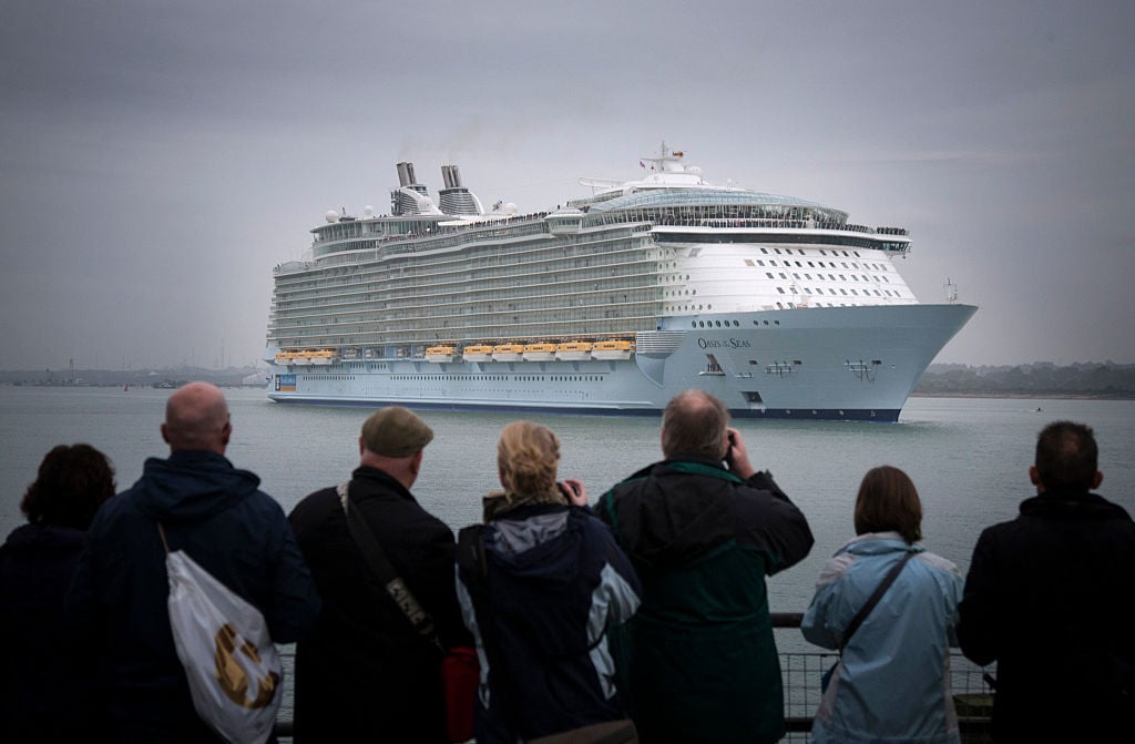 People gather on the waterfront to watch the world's largest cruise ship 'Oasis of the Seas'