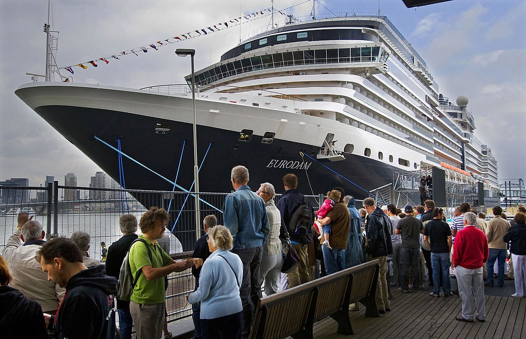 People watch the arrival of the MS Eurodam cruise ship