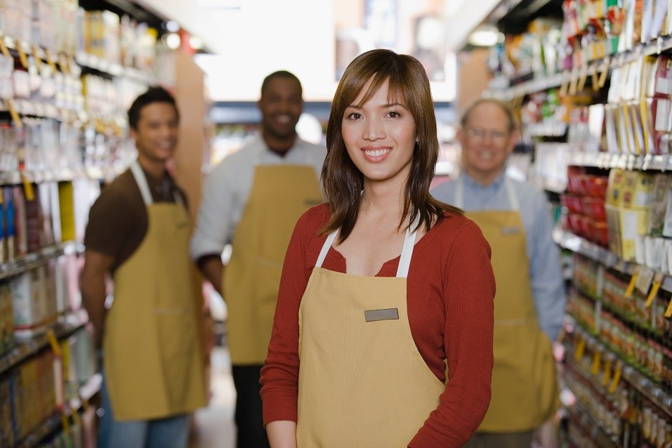 Shop assistants standing in a store aisle