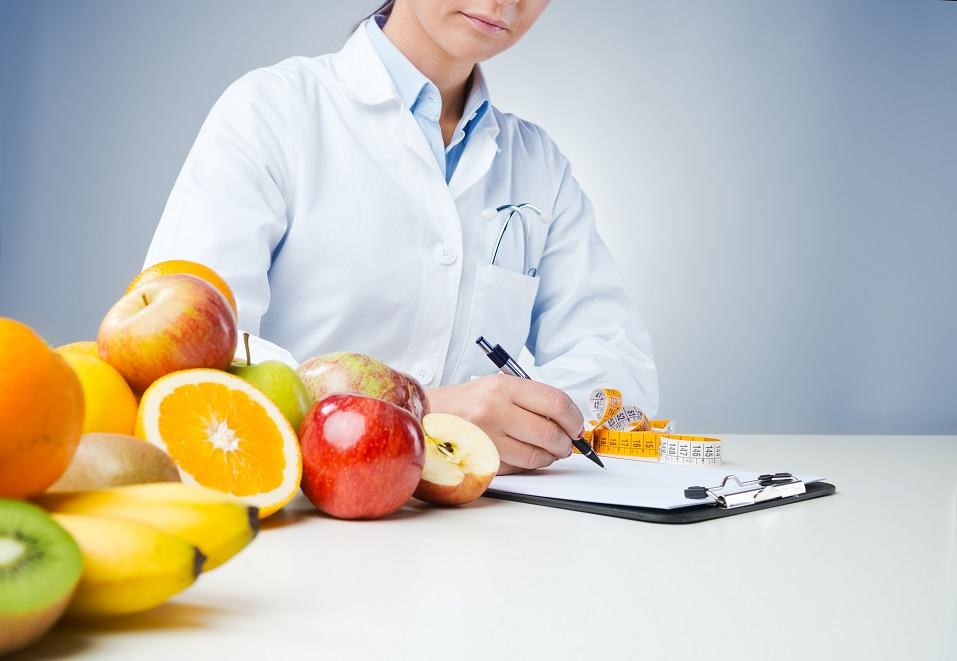 nutritionist working at desk and writing medical records