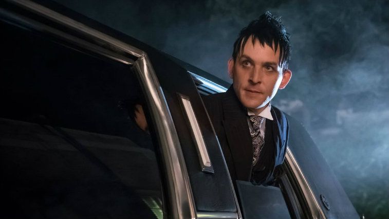 Robin Lord Taylor pokes his head out of a car window in Gotham