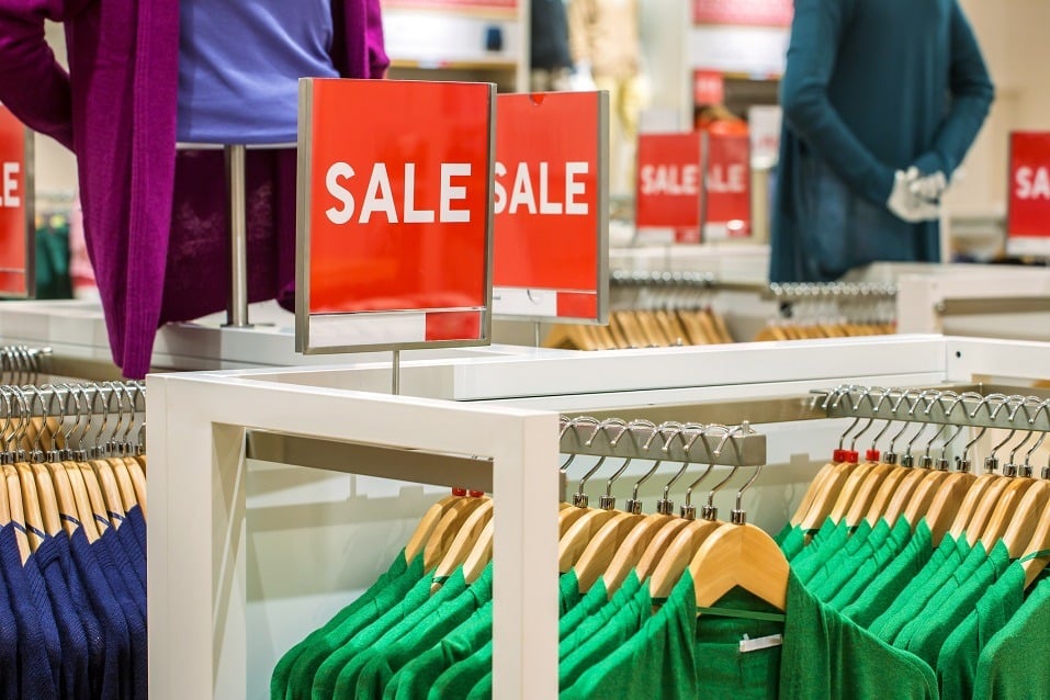 Sale sign over clothing in a store Sale sign over clothing in a store