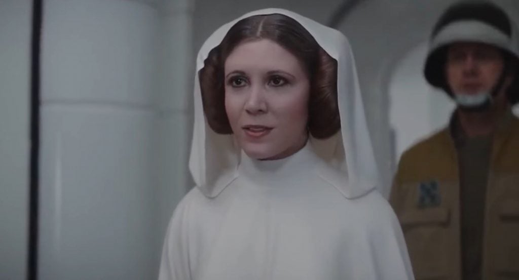 Princess Leia in her trademark white robe and buns, looking off into the distance