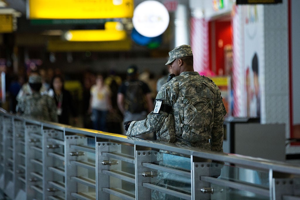 Members of the U.S. Army patrols along a concourse in the departures area at LaGuardia Airport