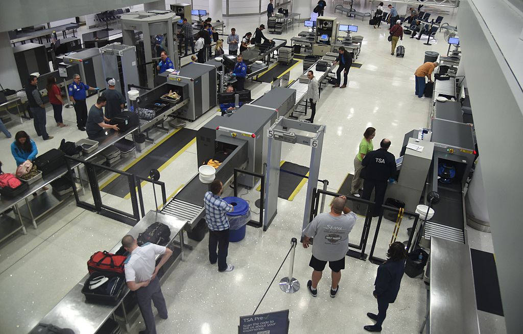US Transportation Security Administration (TSA) officers inspect airline passengers