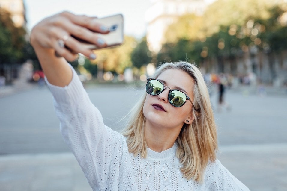 Young woman is taking a selfie
