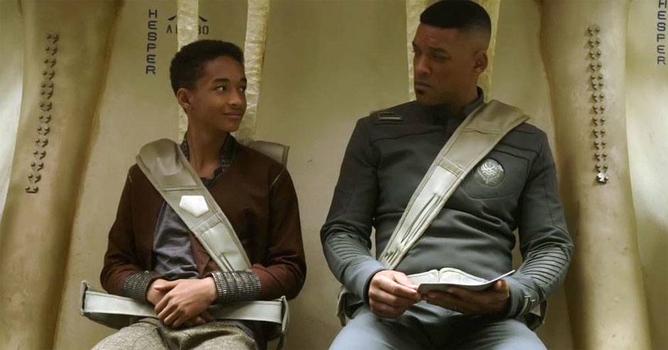 Jaden Smith and Will Smith sit next to each other on a spaceship in a scene from After Earth