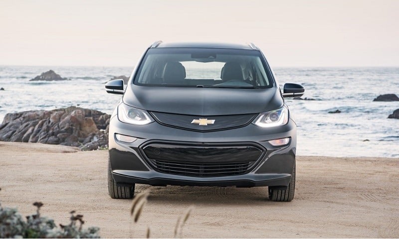 A black 2017 Chevrolet Bolt EV sits parked on the beach
