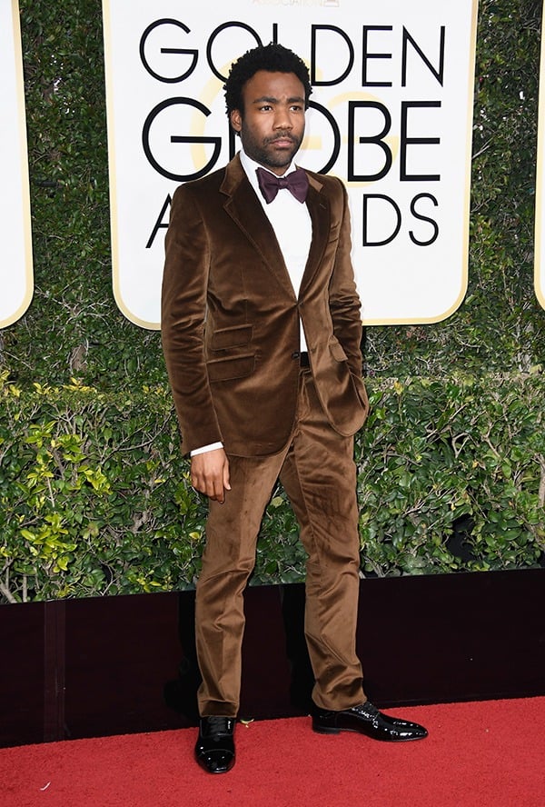 Donald Glover in a brown suit