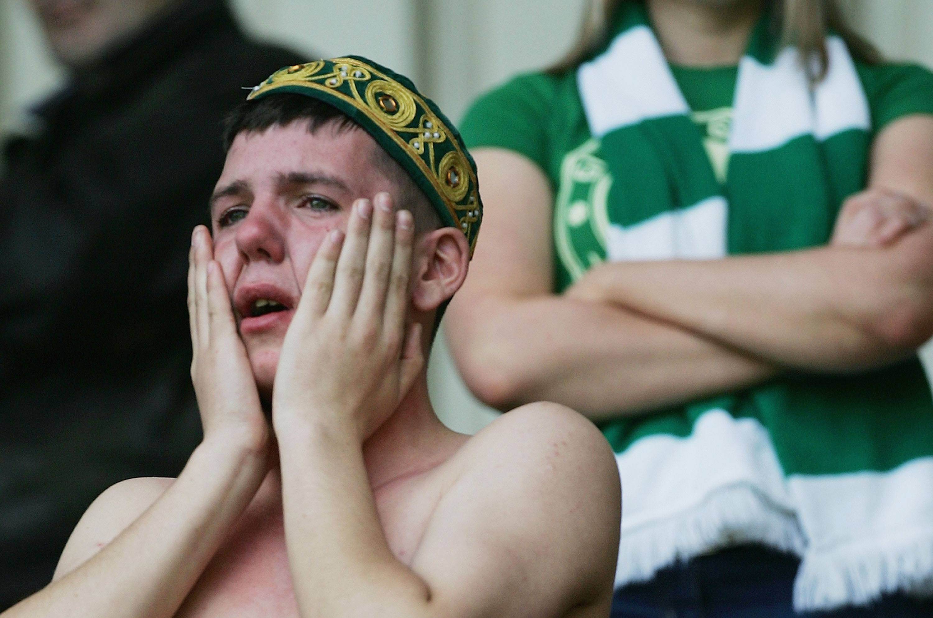 A Celtic fan cries following a loss