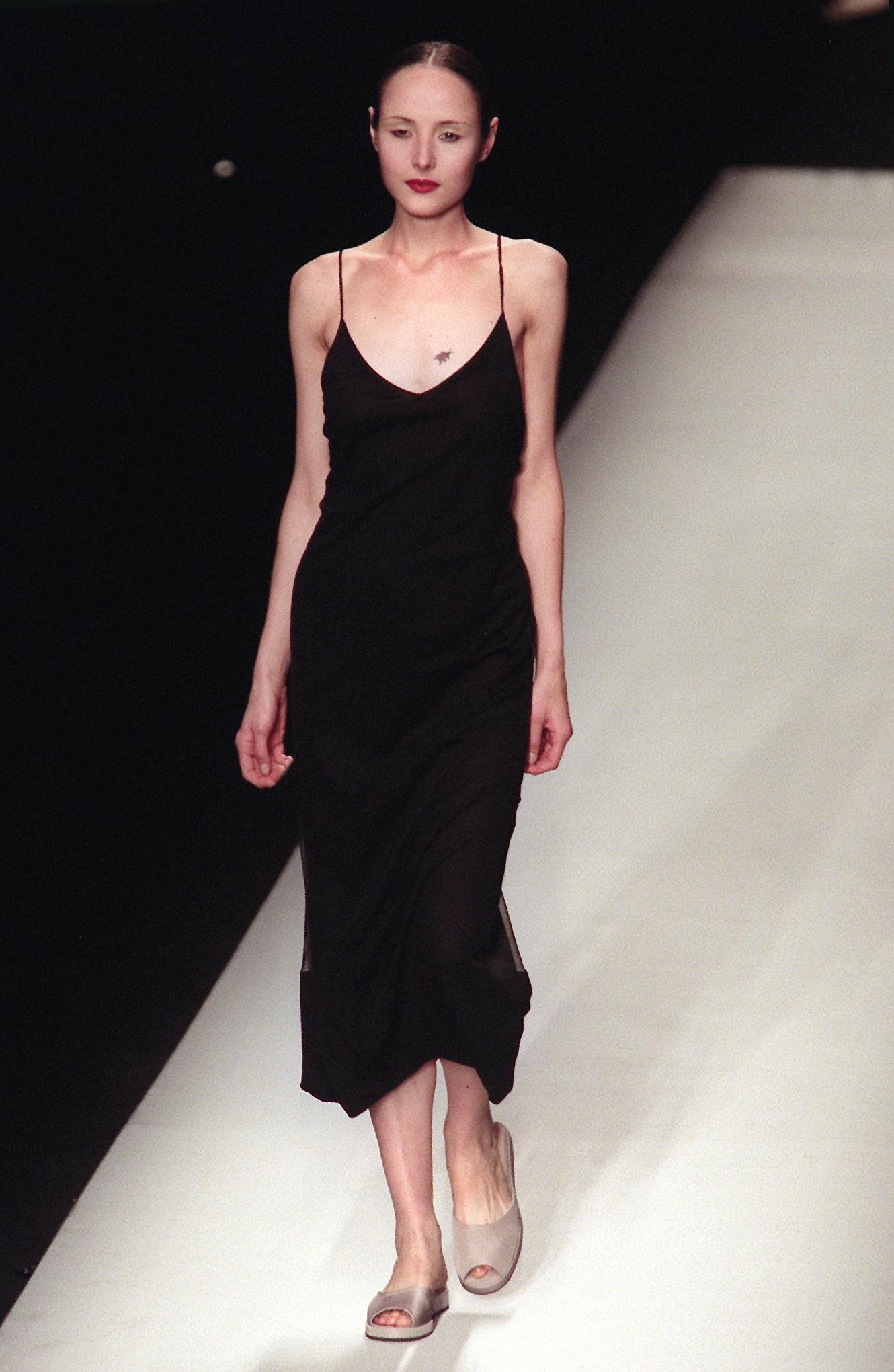 A model wears a black slip dress during the John Bartlett fashion show
