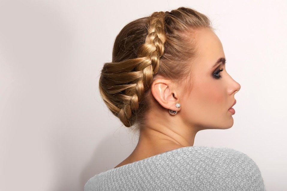 beautiful young blonde woman on a light background