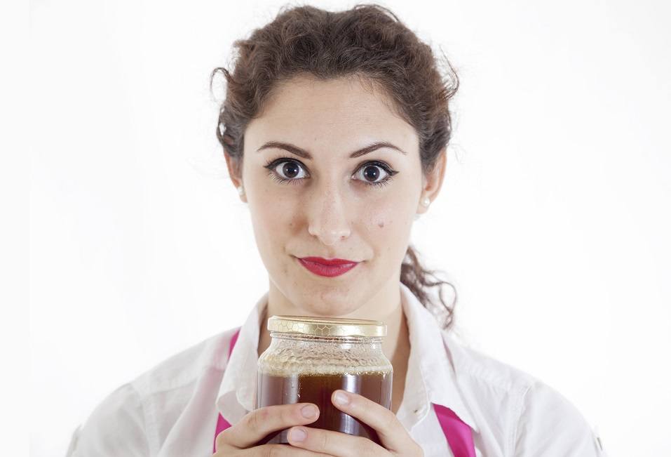 woman with a jar of honey in her hands