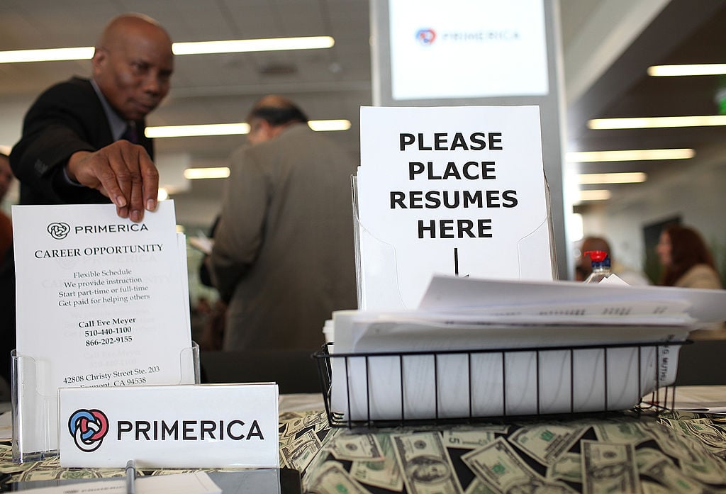 Resumes sit in a basket at the Primerica booth during the Job Hunter's Boot Camp