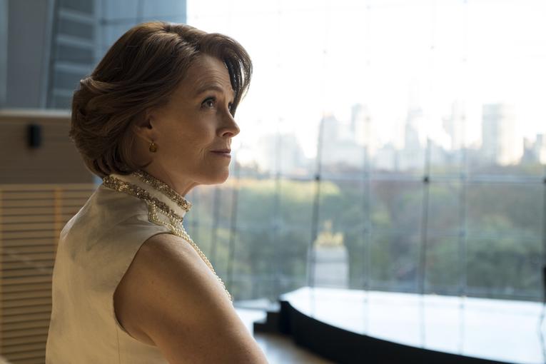 Sigourney Weaver sitting at a desk with a view of the city outside in The Defenders