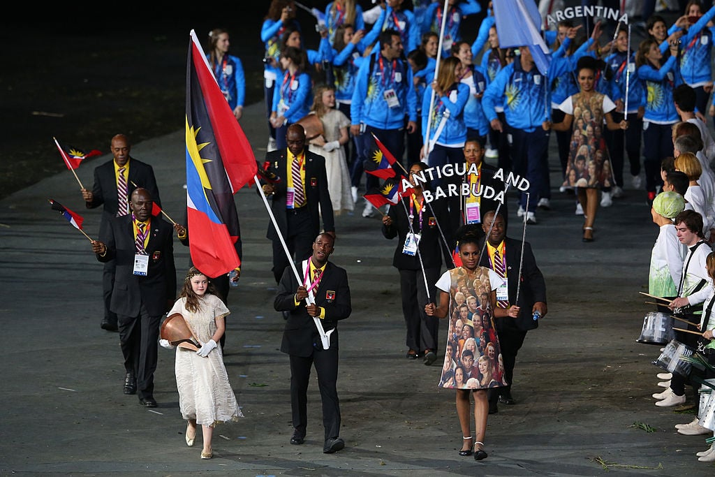 Daniel Bailey of the Antigua and Barbuda Olympic athletics team carries his country's flag