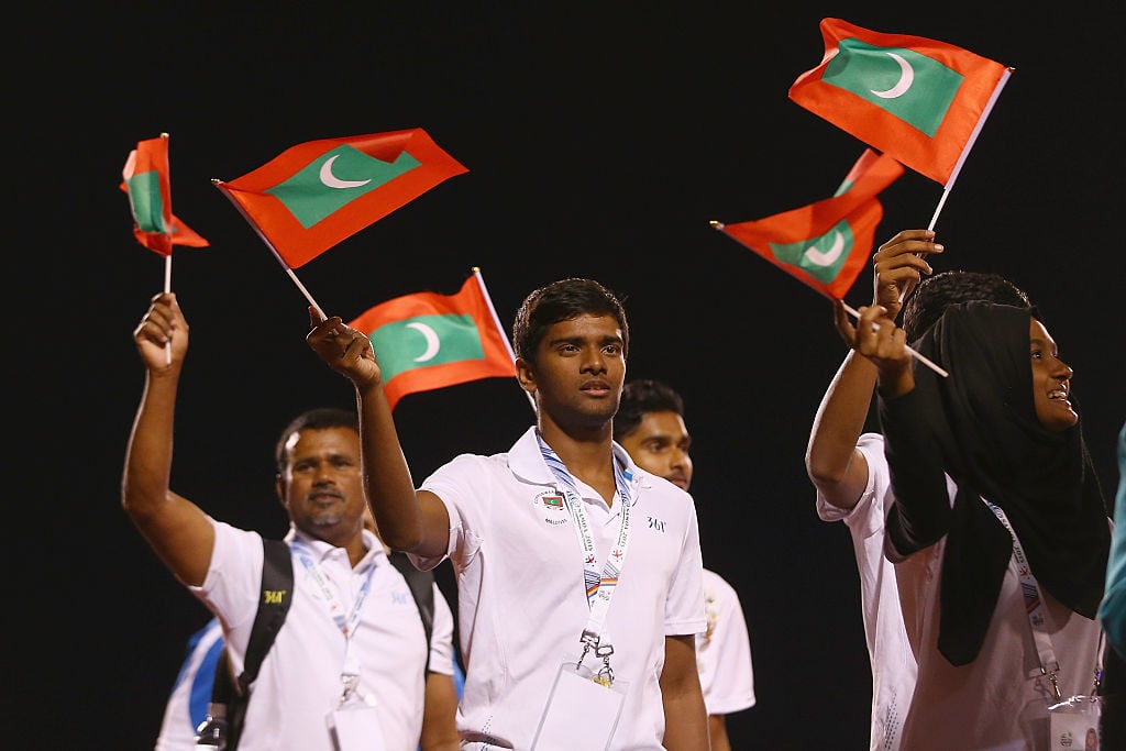 Athletes from the Maldives team waves flags