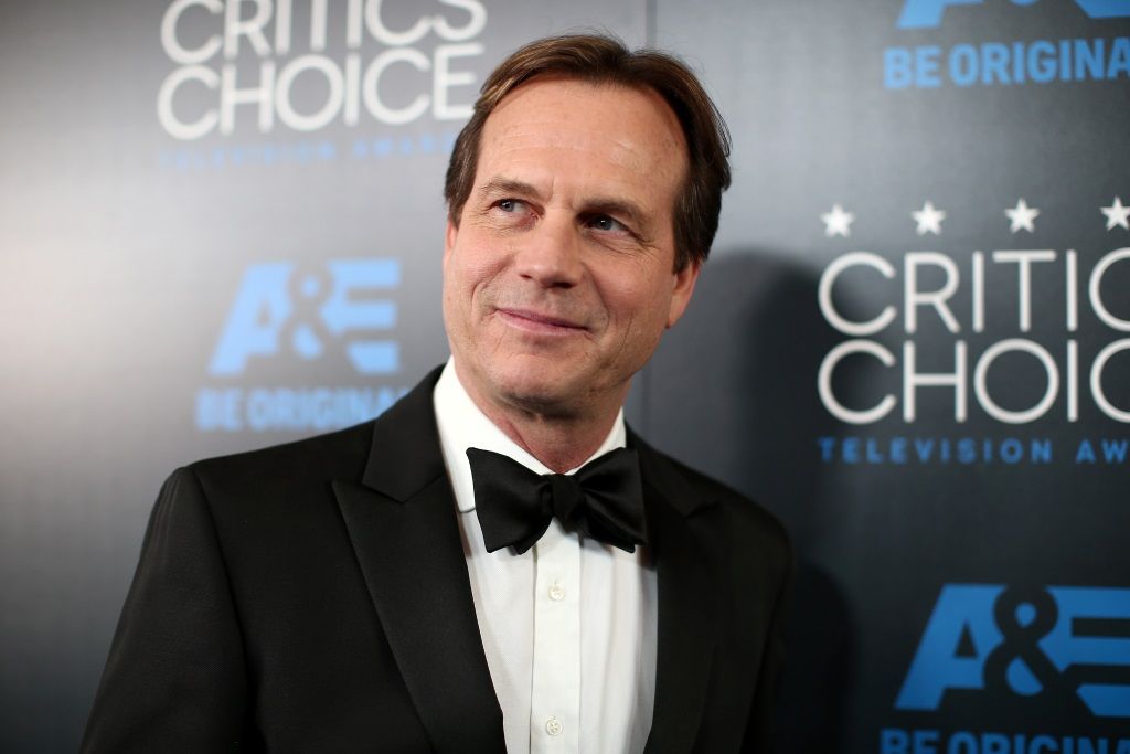 Bill Paxton on the red carpet, looking to his right and smiling