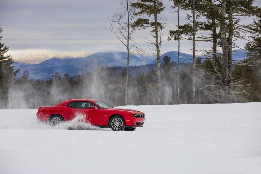A red 2017 Dodge Challenger GT AWD drives in the snow