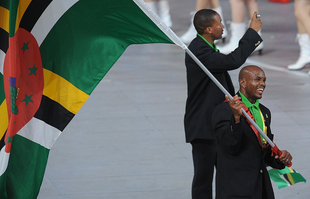 Dominica's flag bearer parades in front of his delegation