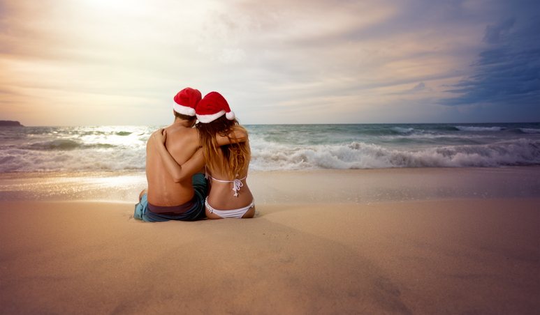 Couple on beach looking at sunset