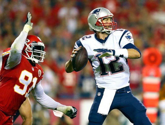 Tom Brady about to throw the foot ball Tom Brady about to throw the foot ball