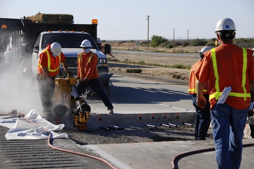 Workers making roadway repairs