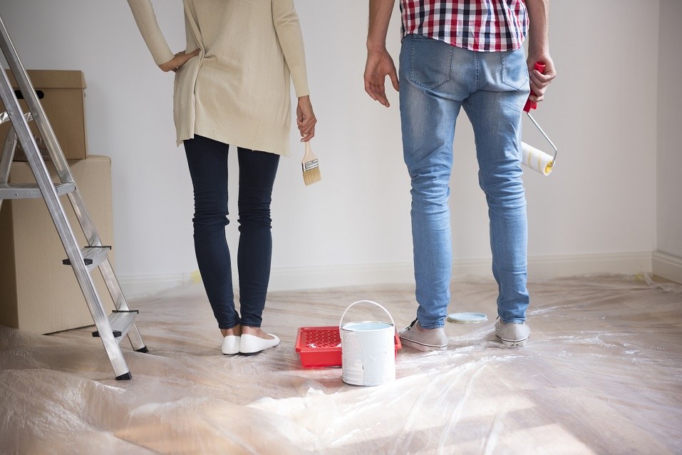 Couple painting wall