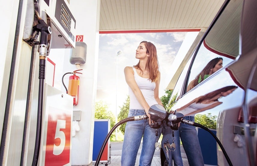 Young woman refuel the car