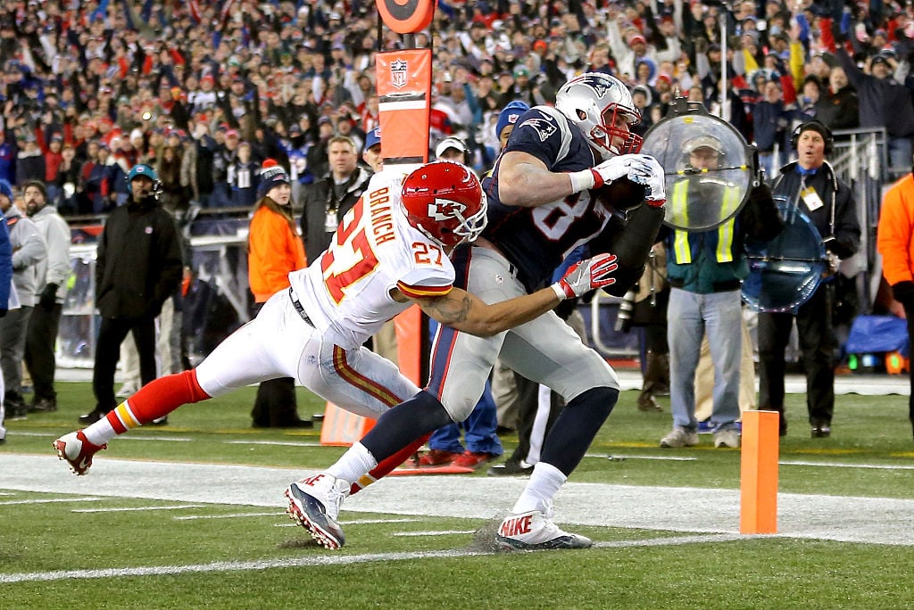 Rob Gronkowski of the New England Patriots catches a touchdown against Tyvon Branch of the Kansas City Chiefs during the AFC Divisional Playoff Game.