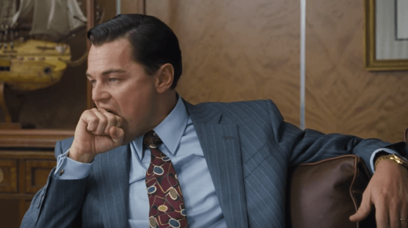 The boss puts his fist in mouth, stops talking