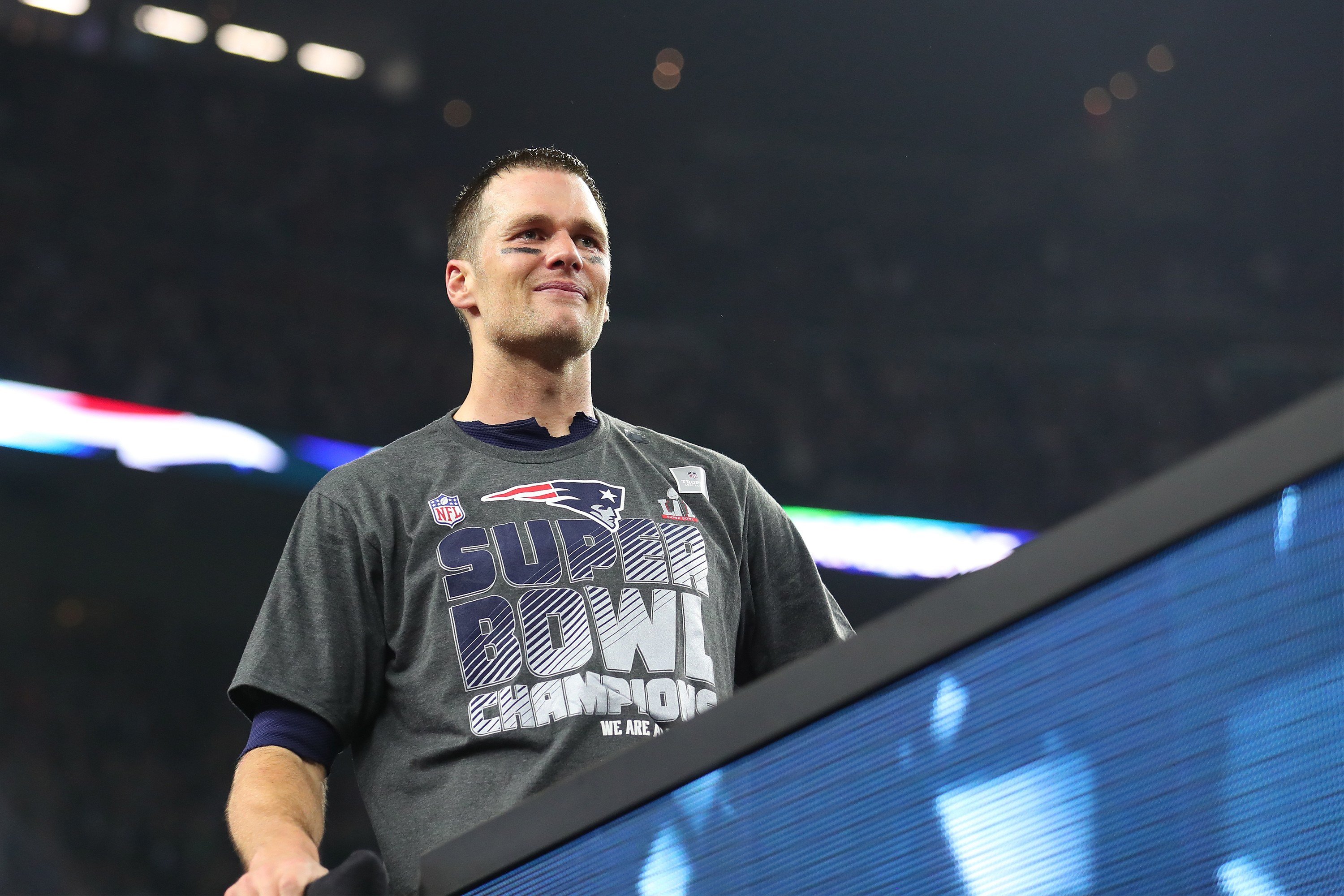 Tom Brady wearing a 'Super Bowl Champion' shirt. Tom Brady wearing a 'Super Bowl Champion' shirt.