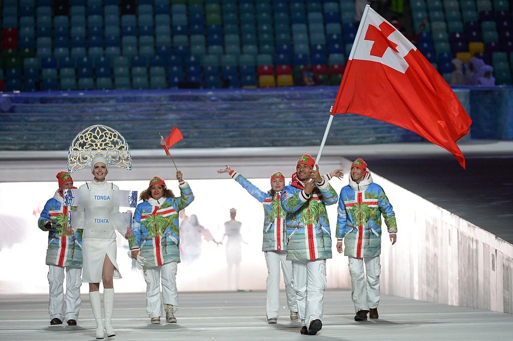 Tonga's flag bearer, luger Bruno Banani, leads his delegation