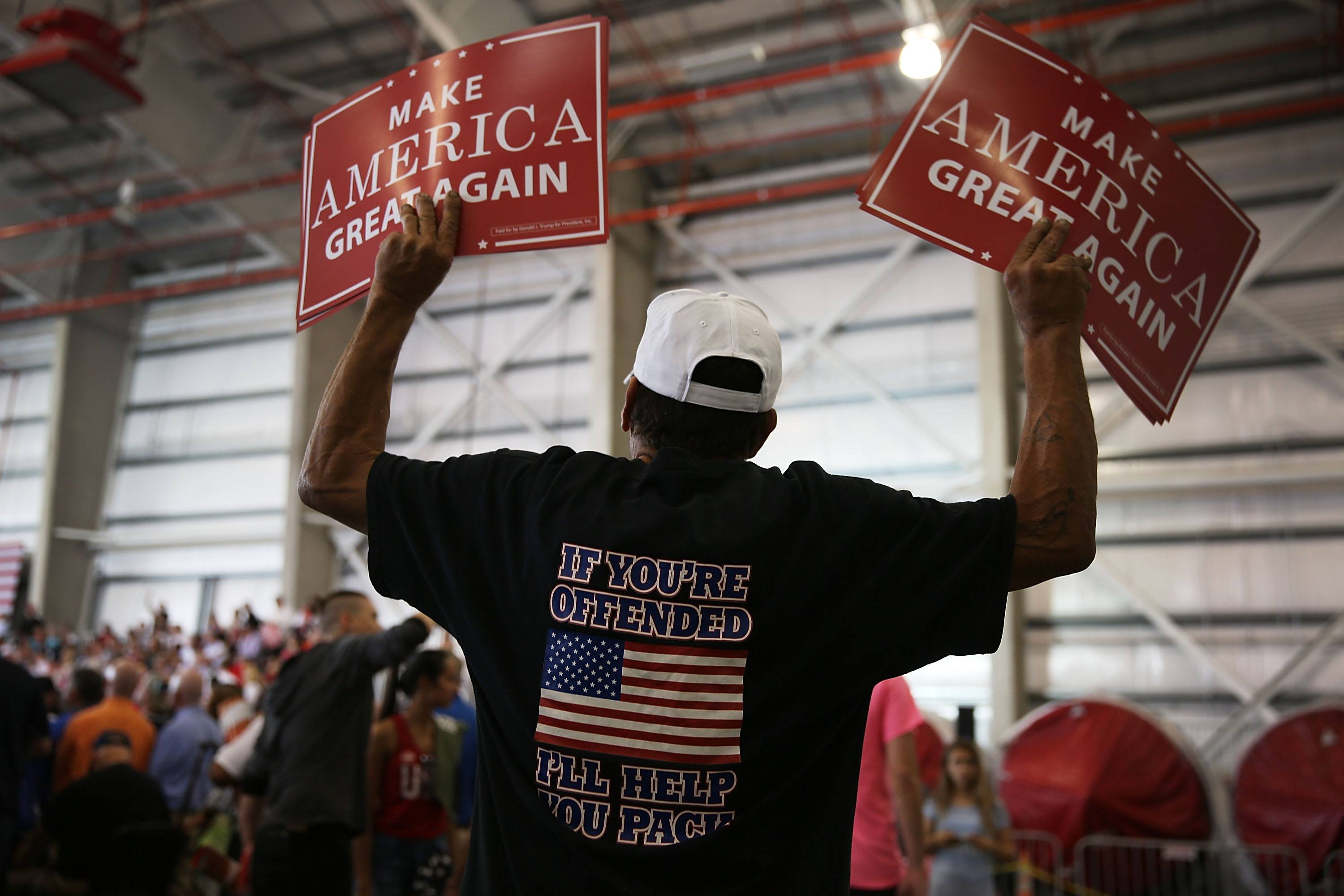 A Trump fan waits for the President at his Florida rally.
