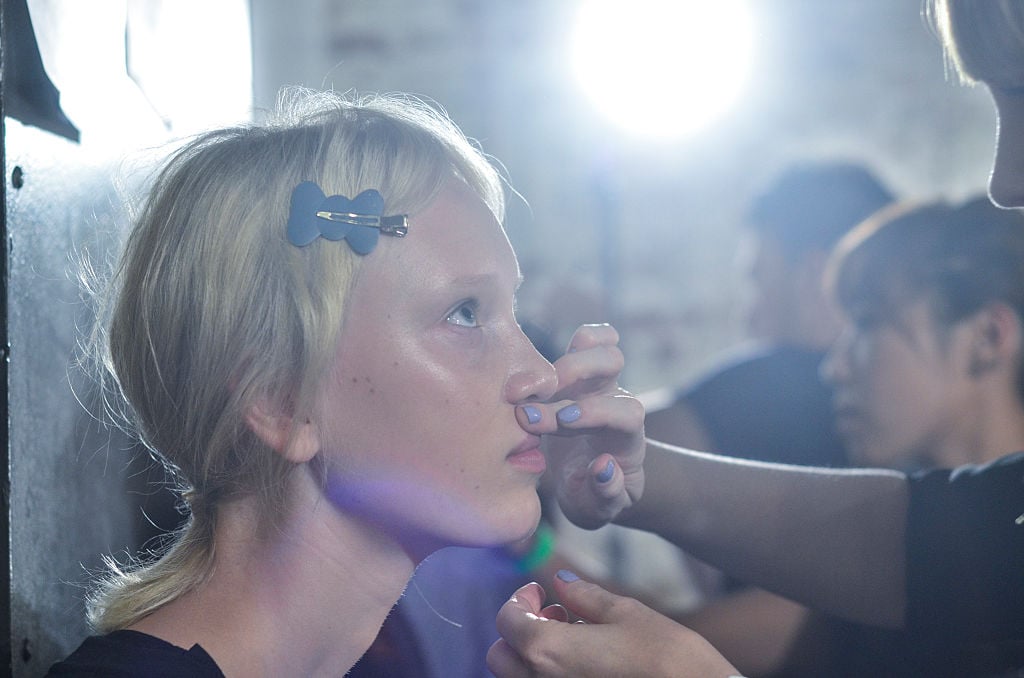 A model's make-up is done during the Ulla Johnson presentation at Skylight