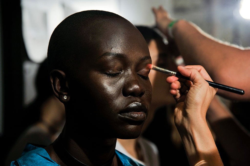 A model's make-up is done during the Ulla Johnson presentation