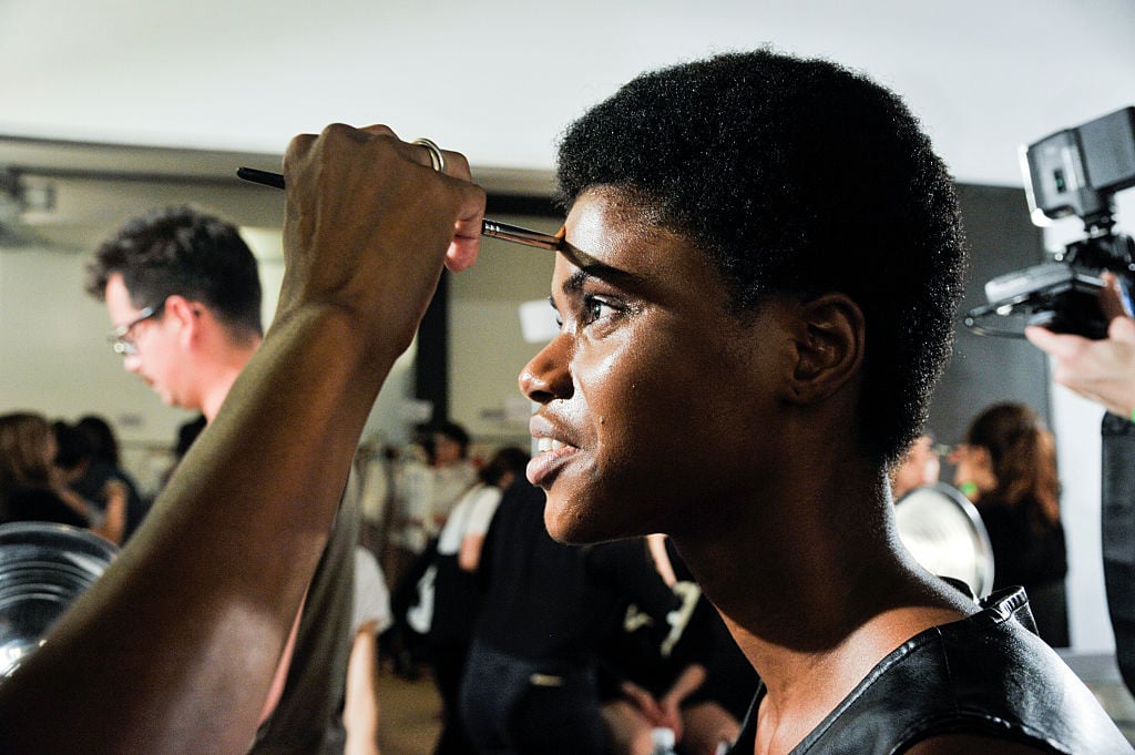 A model's makeup is done during the Ulla Johnson presentation at Skylight