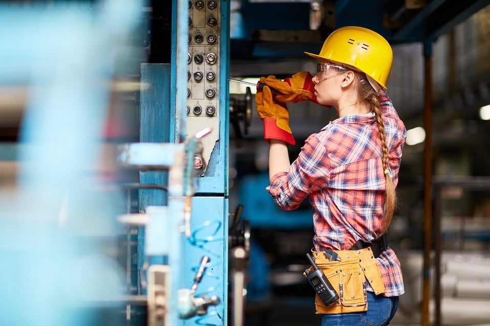 Woman repairs something with screwdriver